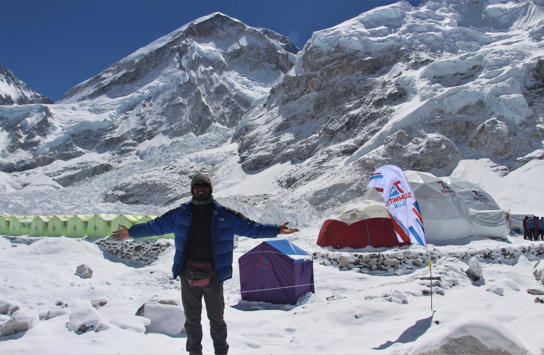 Trekkers hiking towards Everest Base Camp with the Himalayas in the background.