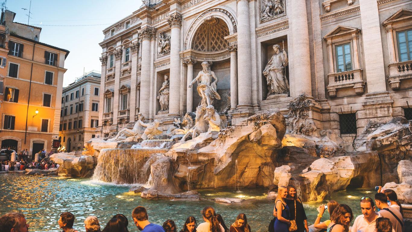 Tourists tossing coins into the Trevi Fountain in Rome